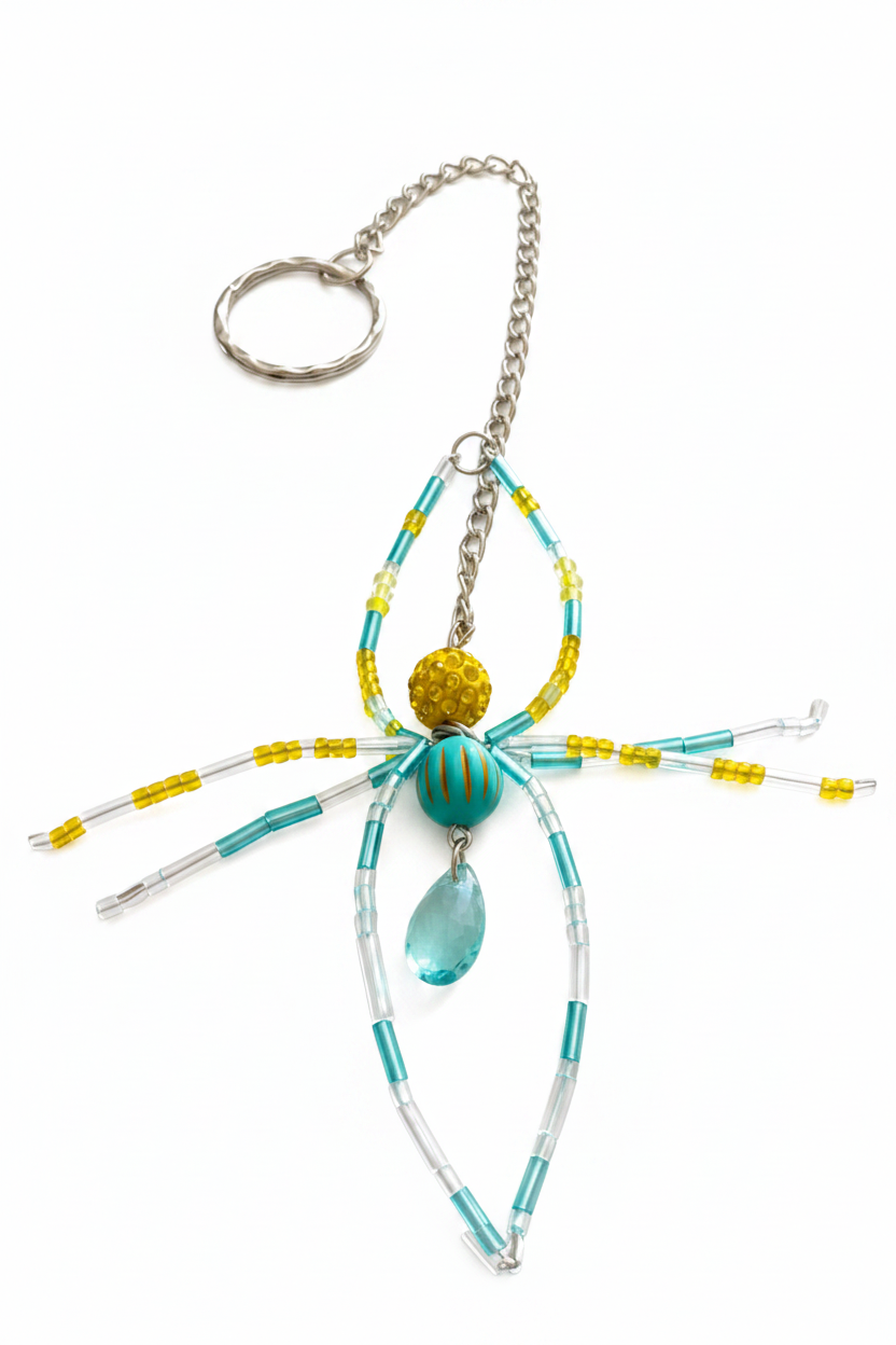 Porte-clés araignée turquoise jaune fond blanc